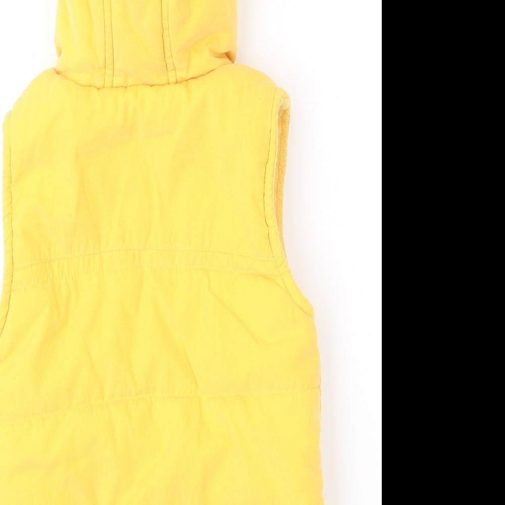 Brand and care label for George girls’ yellow gilet waistcoat, size 6-9, months