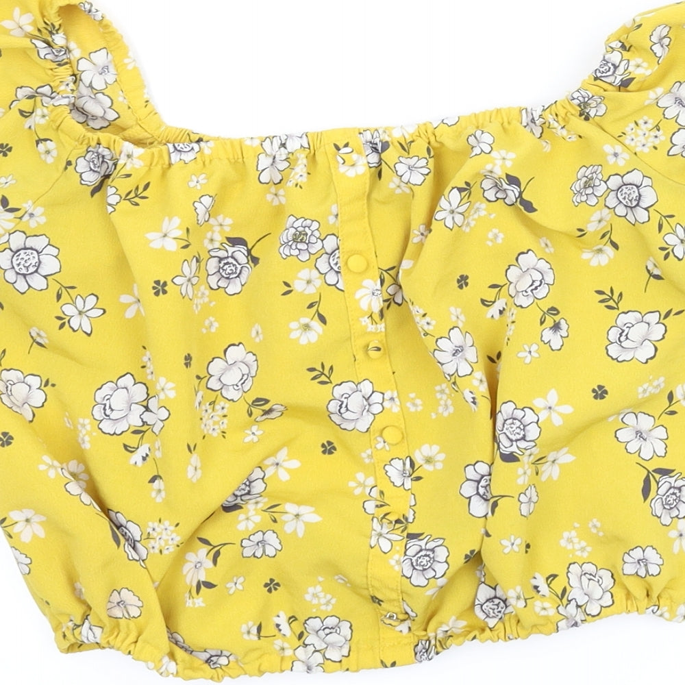 Brand and care label for New Look girls’ yellow floral basic blouse, size 13, years