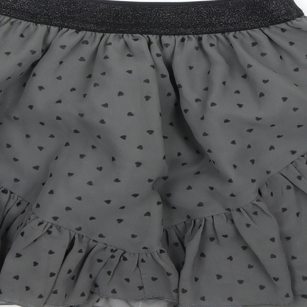 Brand and care label for Marks & Spencer girls’ green polka dot mini skirt, size 6-7, years