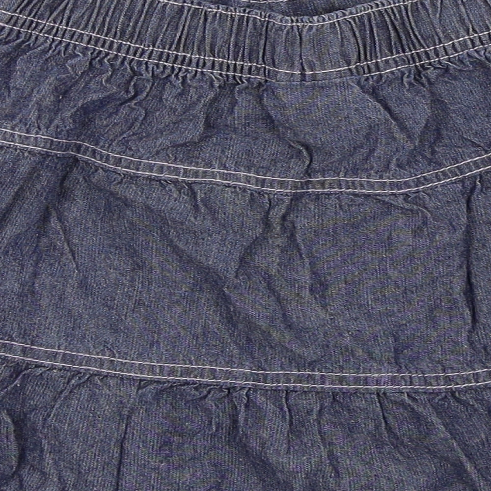 Brand and care label for Cherokee girls’ blue flare skirt, size 5-6, years