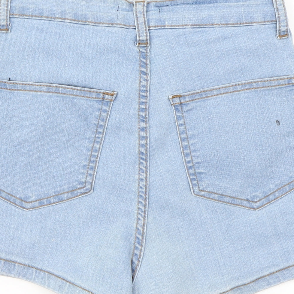 Brand and care label for PRETTYLITTLETHING women’s blue cut-off shorts, size UK 4