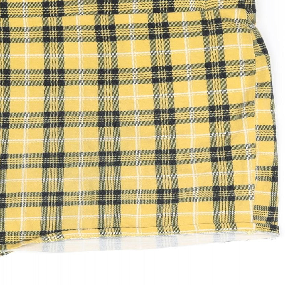 Brand and care label for pre worn girls’ yellow cut-off shorts, size 12-13, years