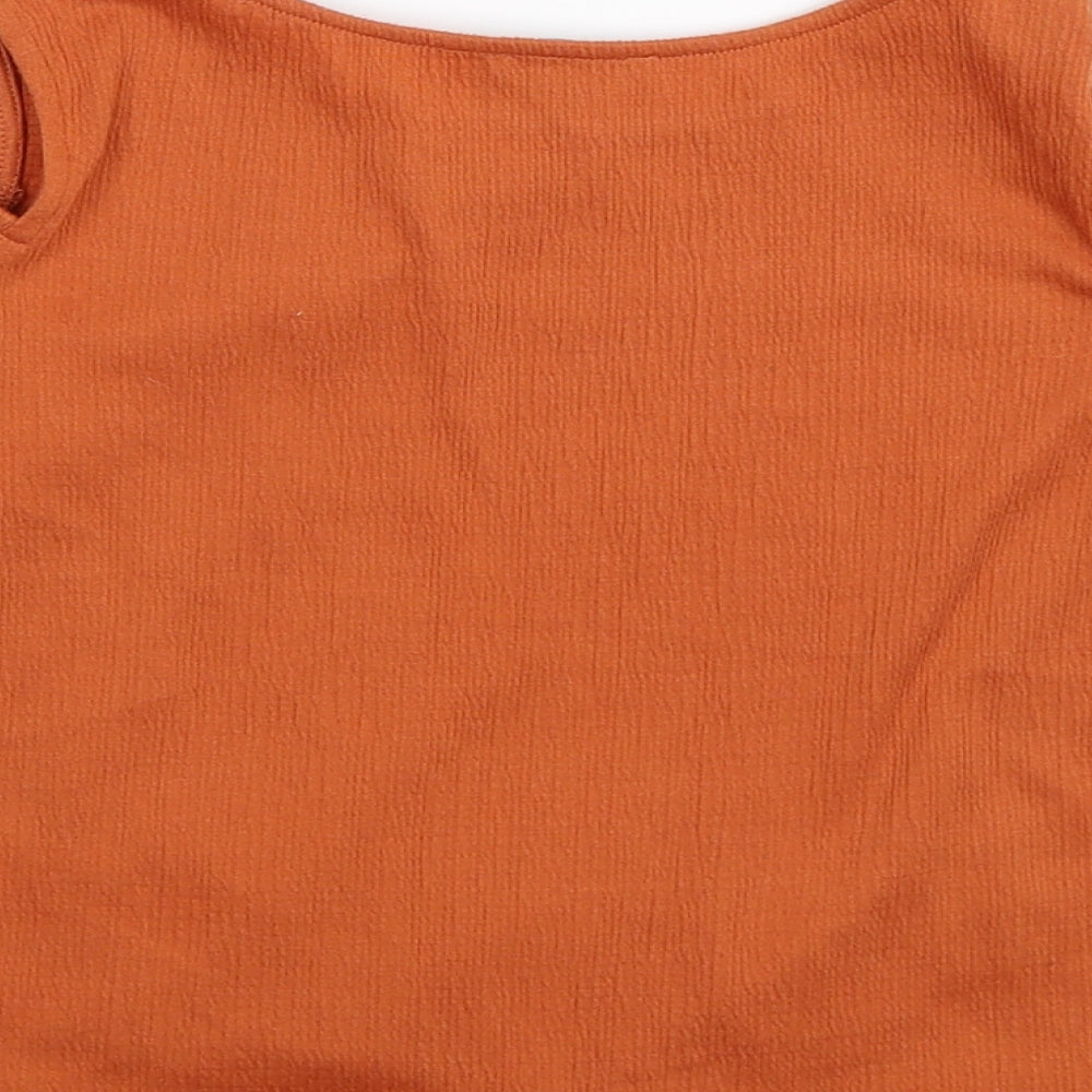 Brand and care label for Primark girls’ orange cropped t-shirt, size 7-8, years - cold shoulder
