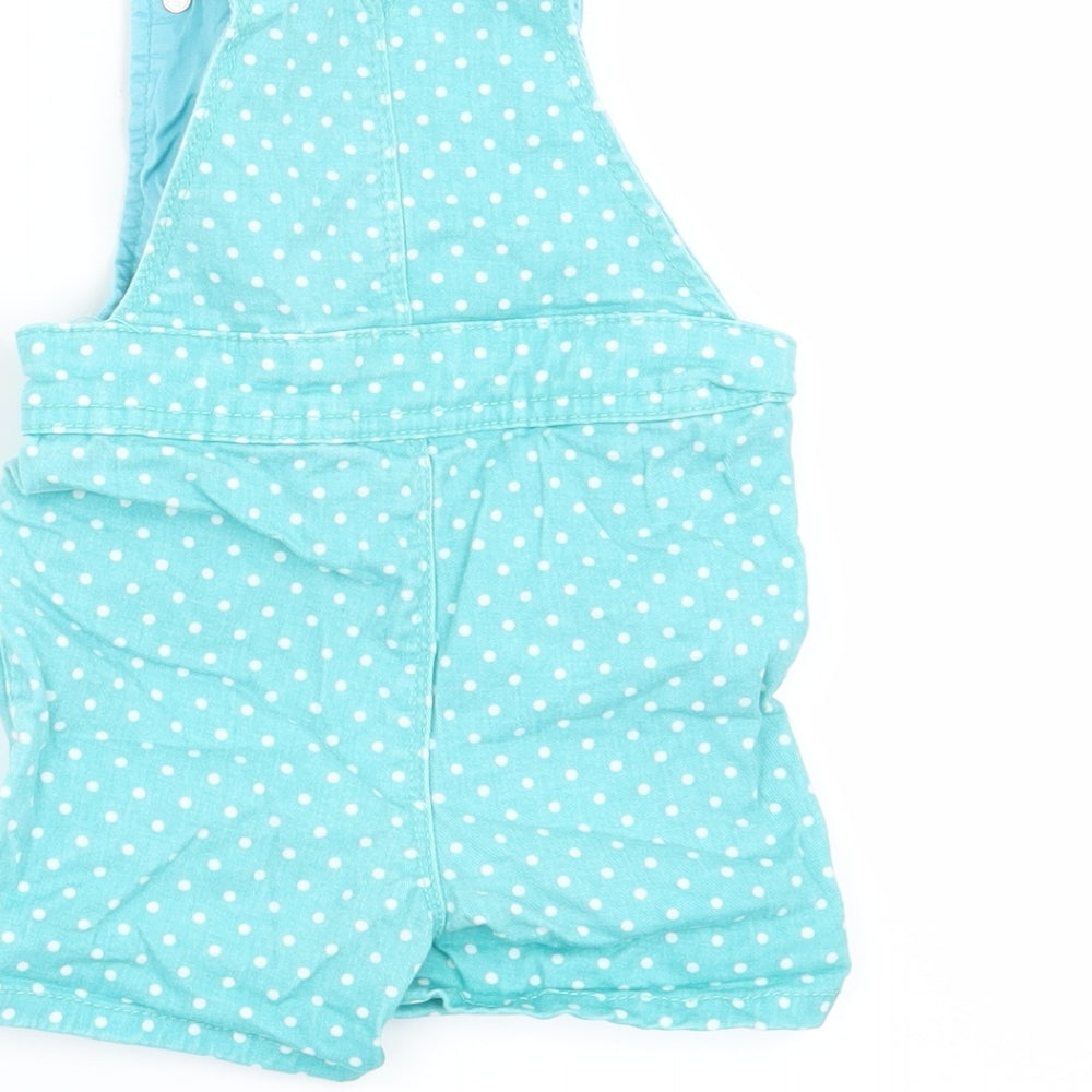 Brand and care label for M&Co girls’ green polka dot dungaree one-piece, size 6-9, months