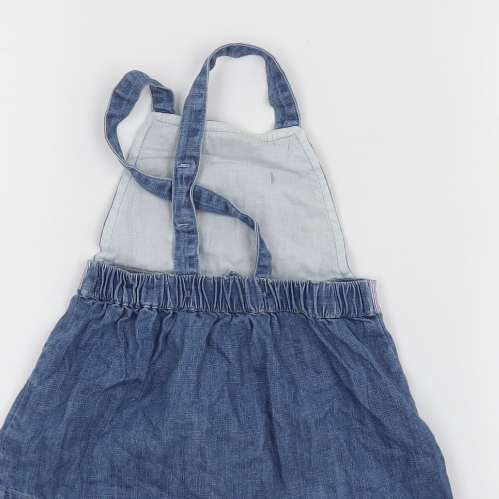 Brand and care label for Matalan girls’ blue pinafore/dungaree dress, size 6-9, months