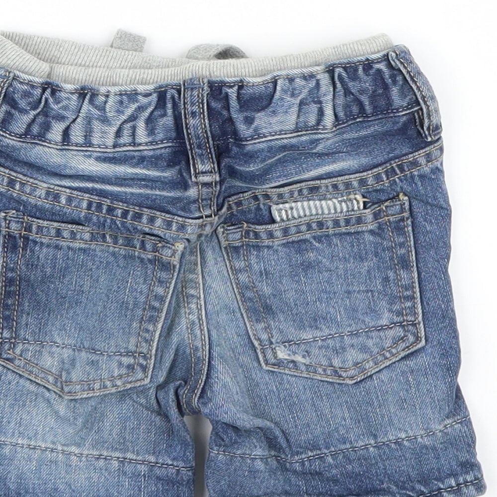 Brand and care label for Gap boys’ blue denim capri jeans, size 6-9, months