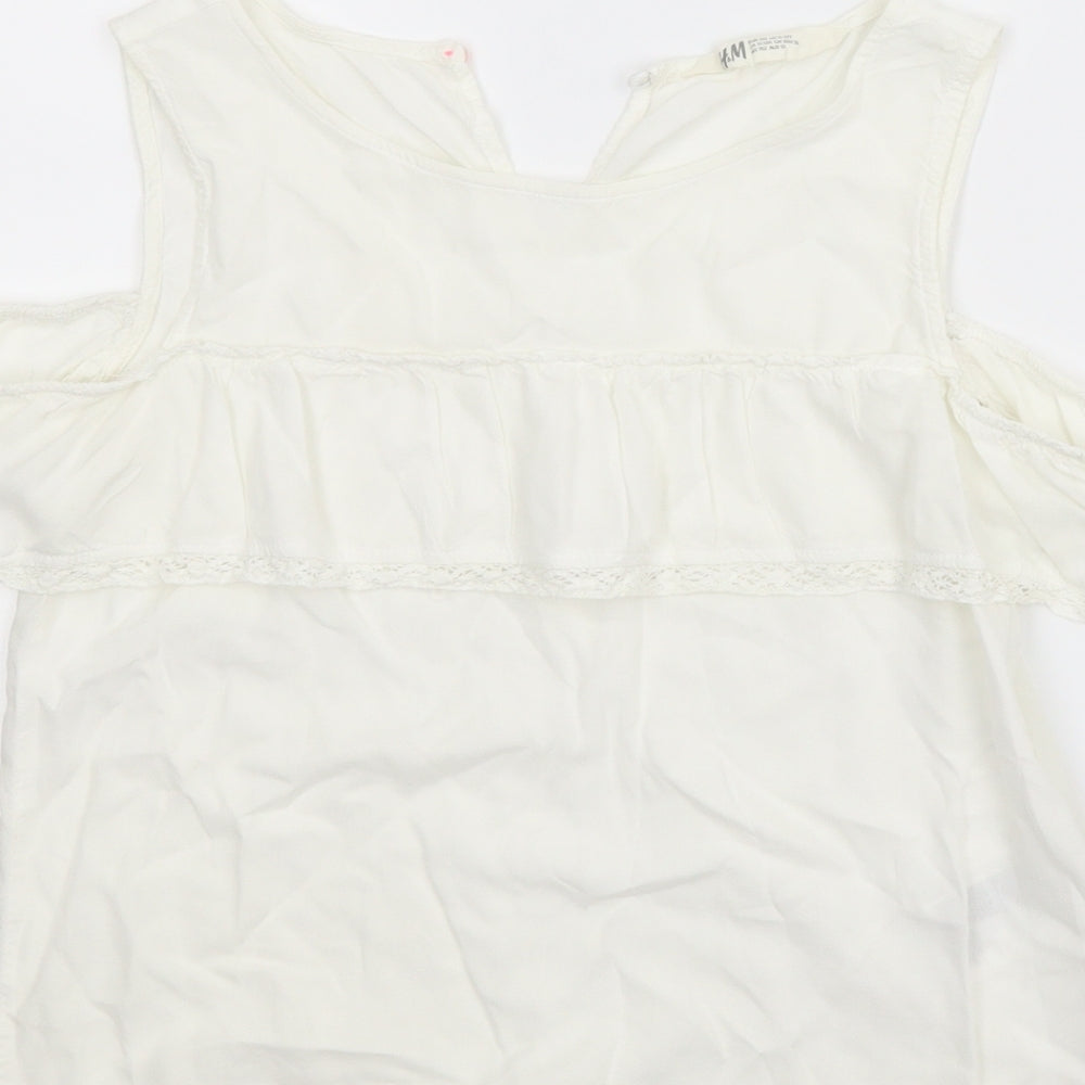 Brand and care label for H&M girls’ white basic blouse, size 11-12, years