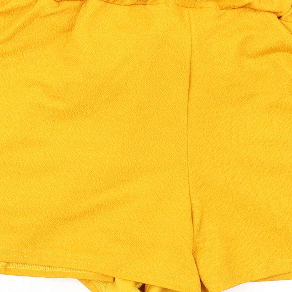 Brand and care label for PRETTYLITTLETHING women’s yellow paperbag shorts, size UK 6