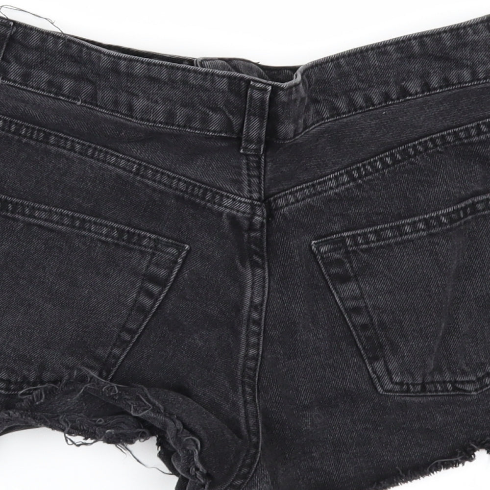 Brand and care label for Topshop women’s black denim cut-off shorts, size UK 26