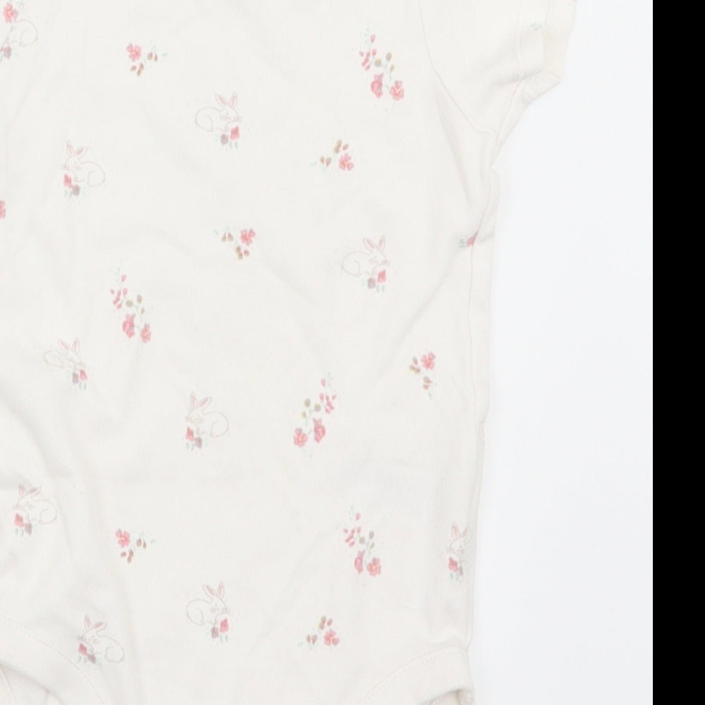 Brand and care label for Next girls’ white animal print babygrow one-piece, size 12-18, months