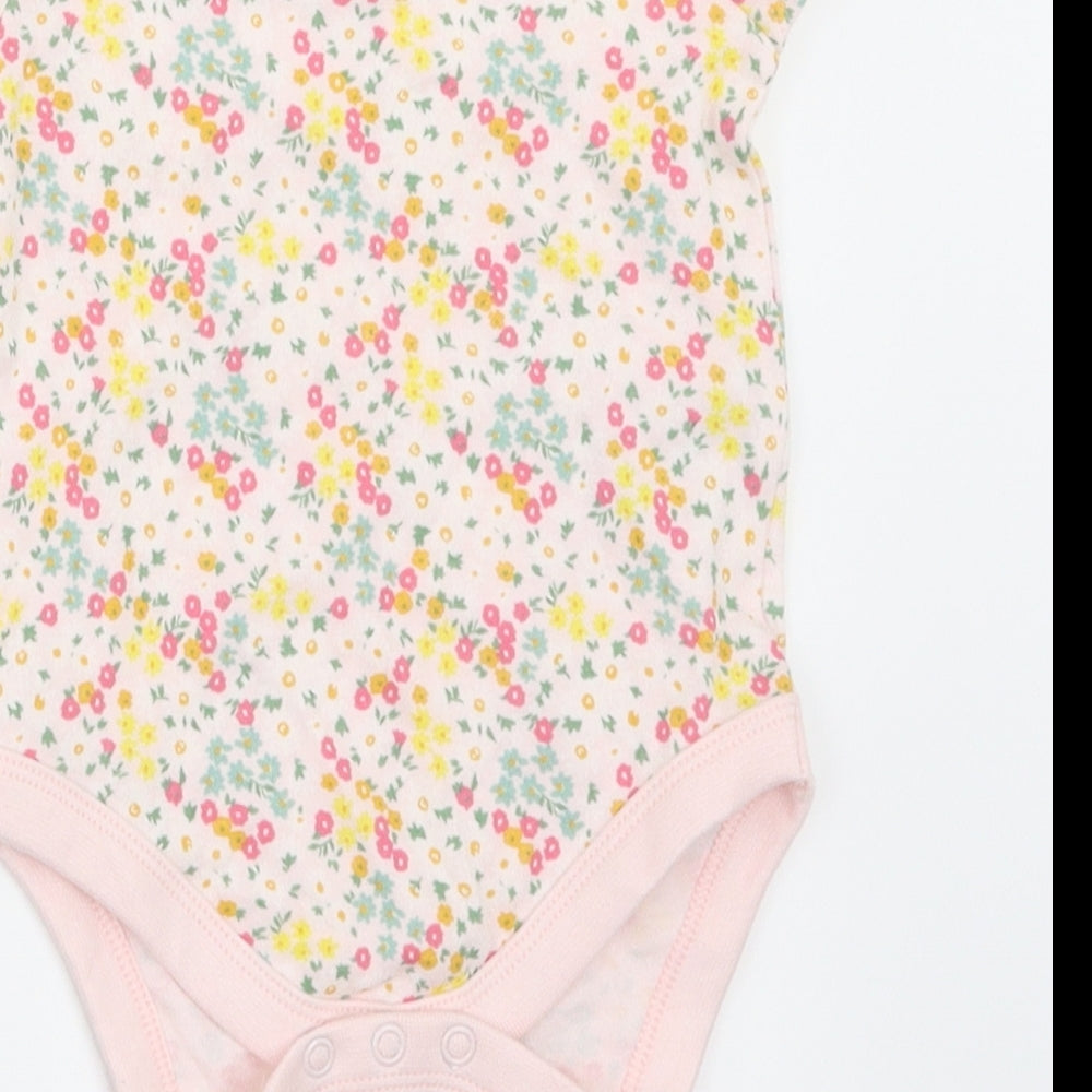 Brand and care label for F&F girls’ multicoloured floral babygrow one-piece, size 3-6, months