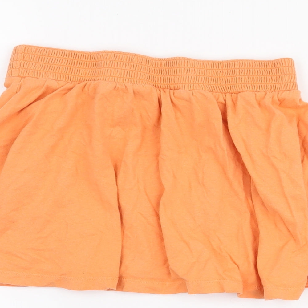 Brand and care label for Cherokee girls’ orange a-line skirt, size 9-10, years