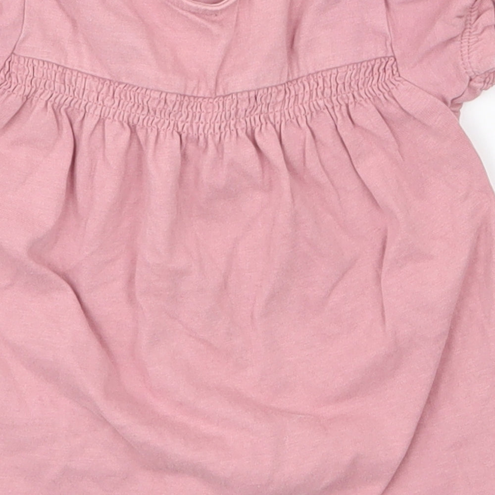 Brand and care label for Tu kids girls’ pink a-line, size 12-18, months