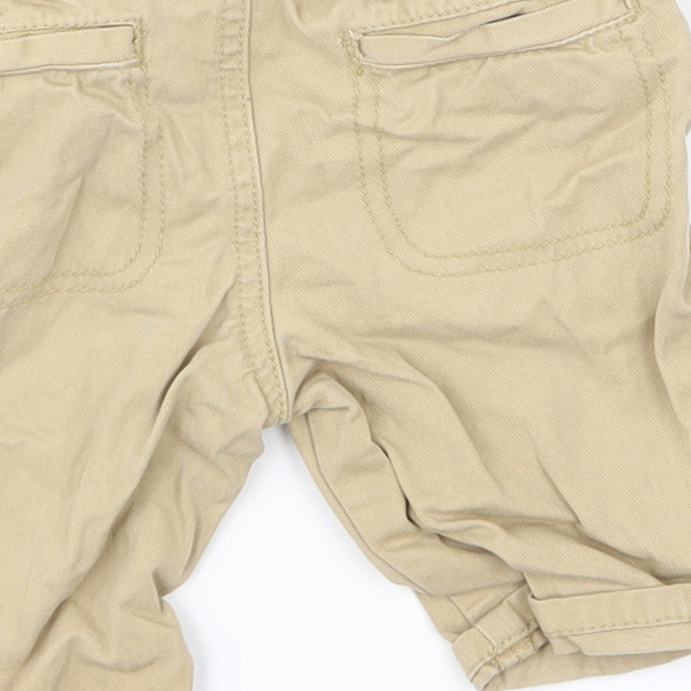 Brand and care label for Nutmeg boys’ beige cargo jeans, size 18-24, months