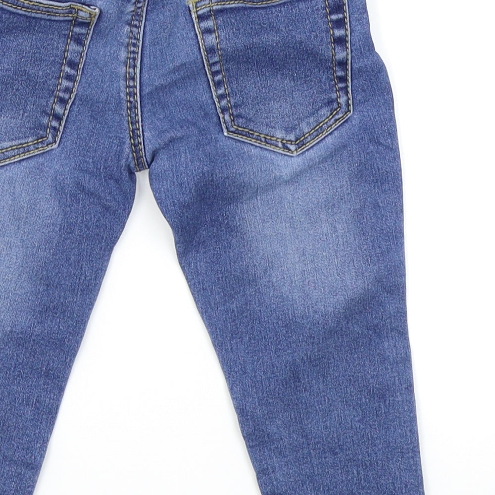 Brand and care label for Evie Angel girls’ blue cargo jeans, size 12-18, months