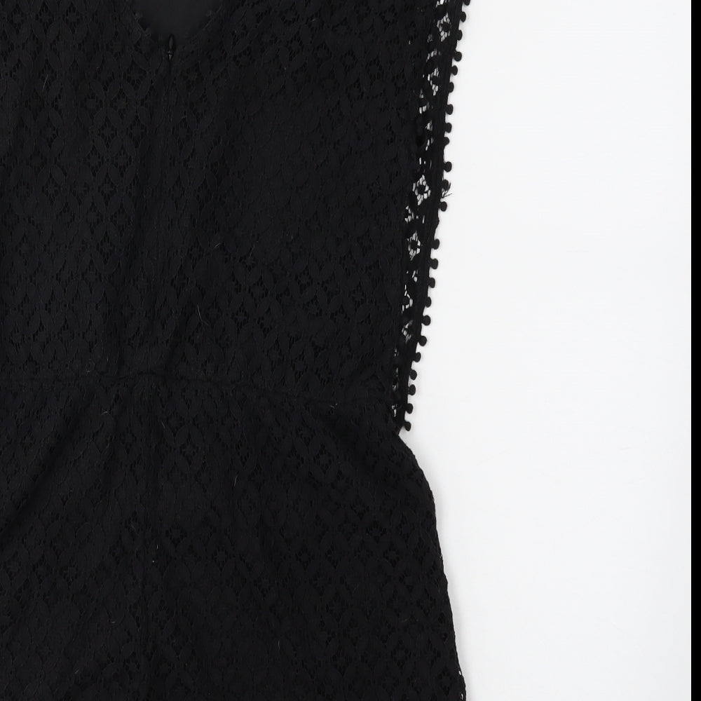 Brand and care label for Boohoo women’s black jumpsuit one-piece, size UK 12