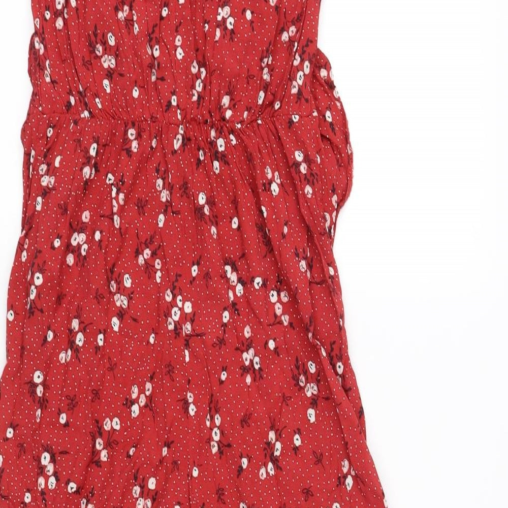 Brand and care label for Miss Selfridge women’s red jumpsuit one-piece, size UK 4