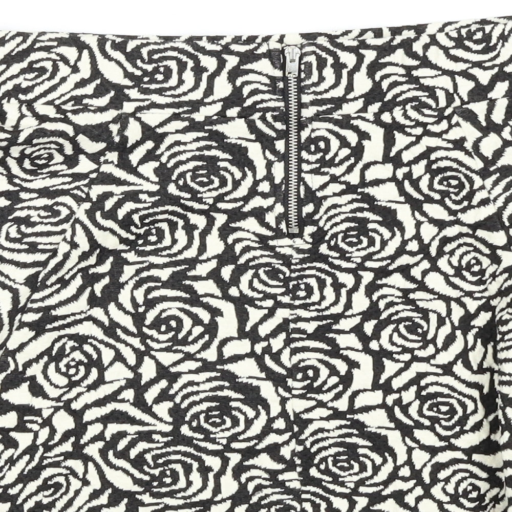 Brand and care label for H&M women’s white floral a-line skirt, size UK 8