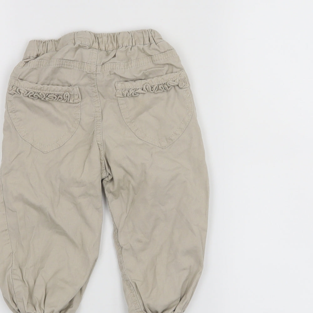 Brand and care label for H&M girls’ beige cropped trousers, size 12, months