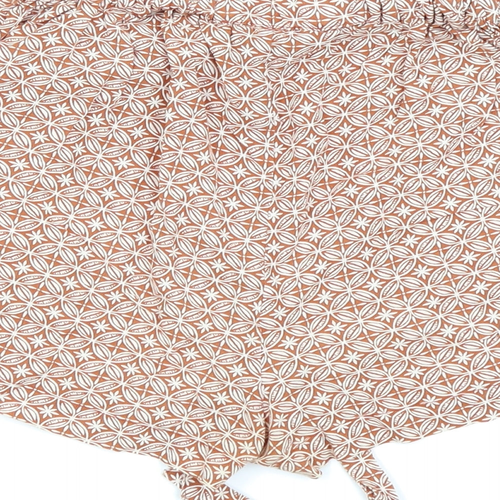Brand and care label for Primark women’s beige floral hot pants shorts, size UK 6