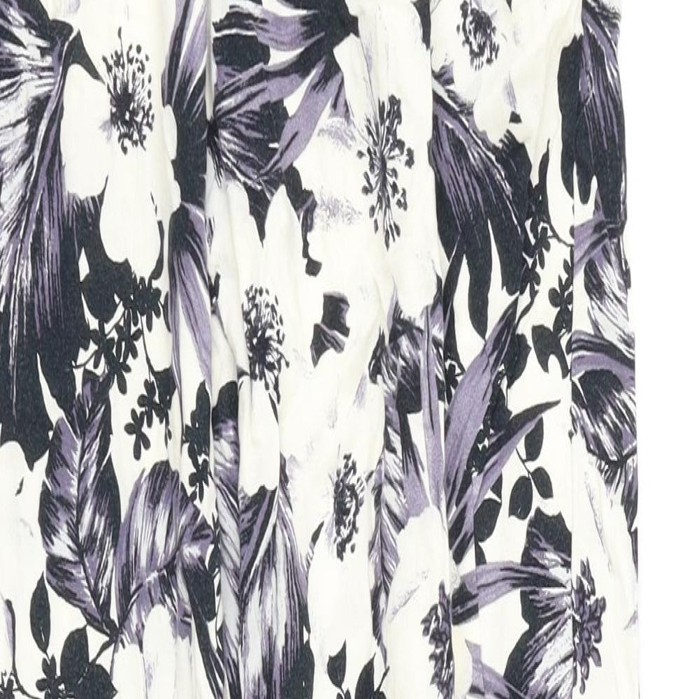 Brand and care label for Dorothy Perkins women’s white floral jogger trousers, size UK 6
