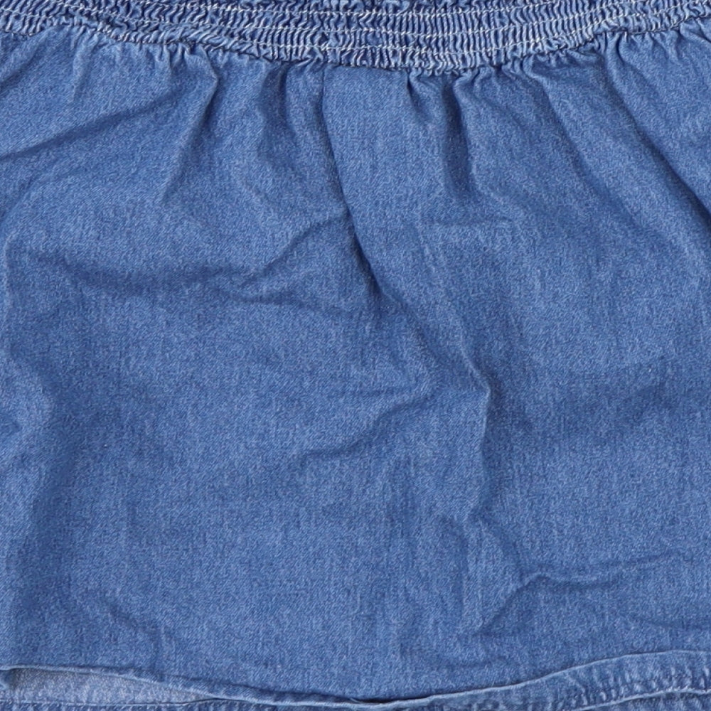 Brand and care label for Tu girls’ blue a-line skirt, size 10, years