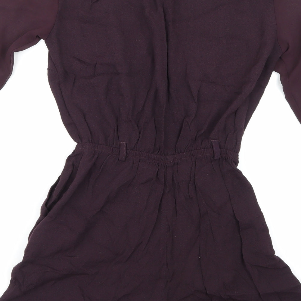 Brand and care label for River Island women’s purple playsuit one-piece, size UK 6