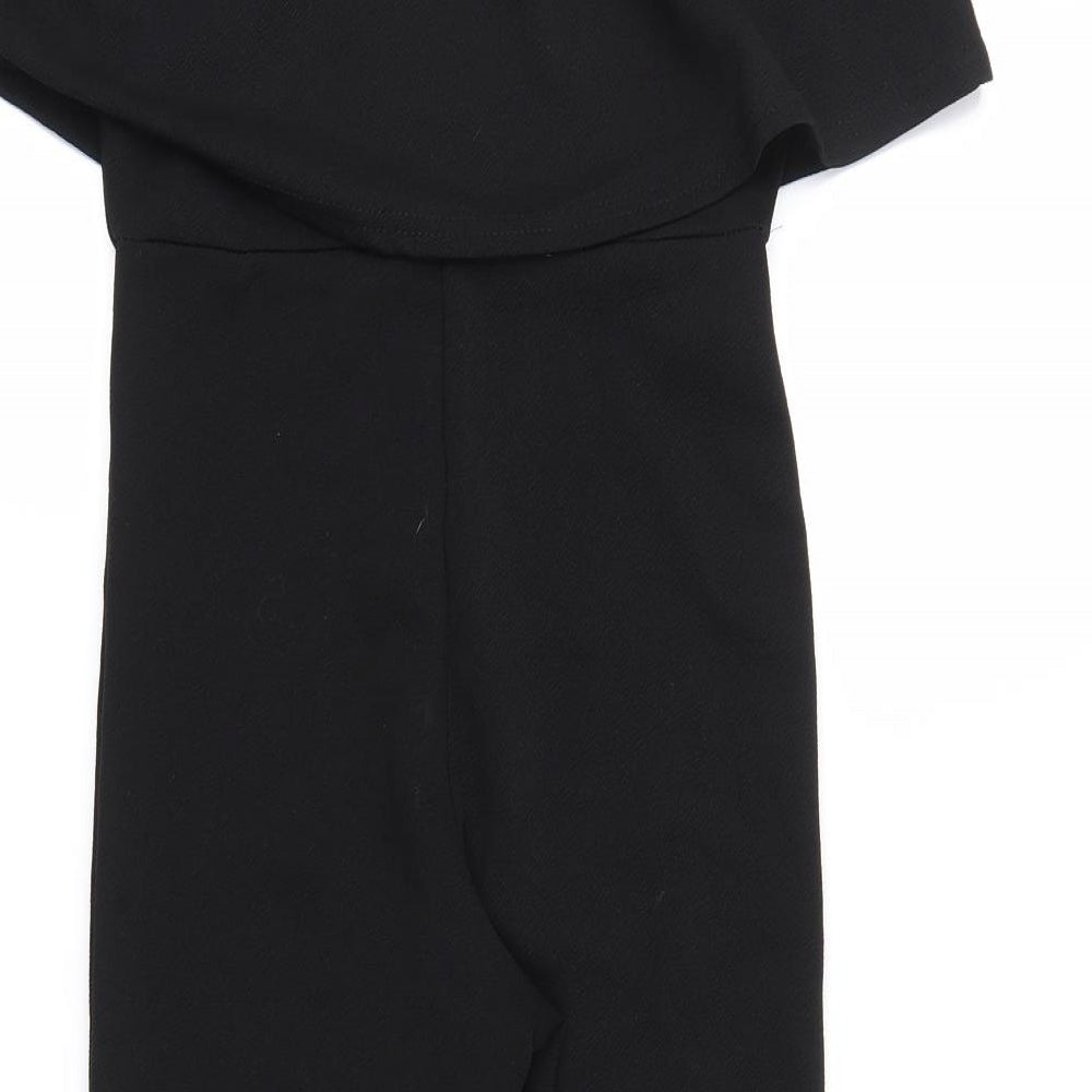 Brand and care label for Missguided women’s black jumpsuit one-piece, size UK 8