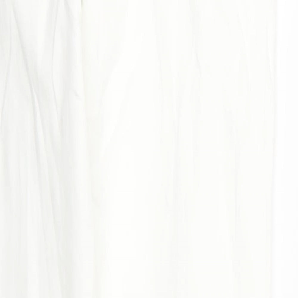 Brand and care label for Topshop women’s white skinny jeans, size UK 28, in, 32-inch leg - ripped distressed look
