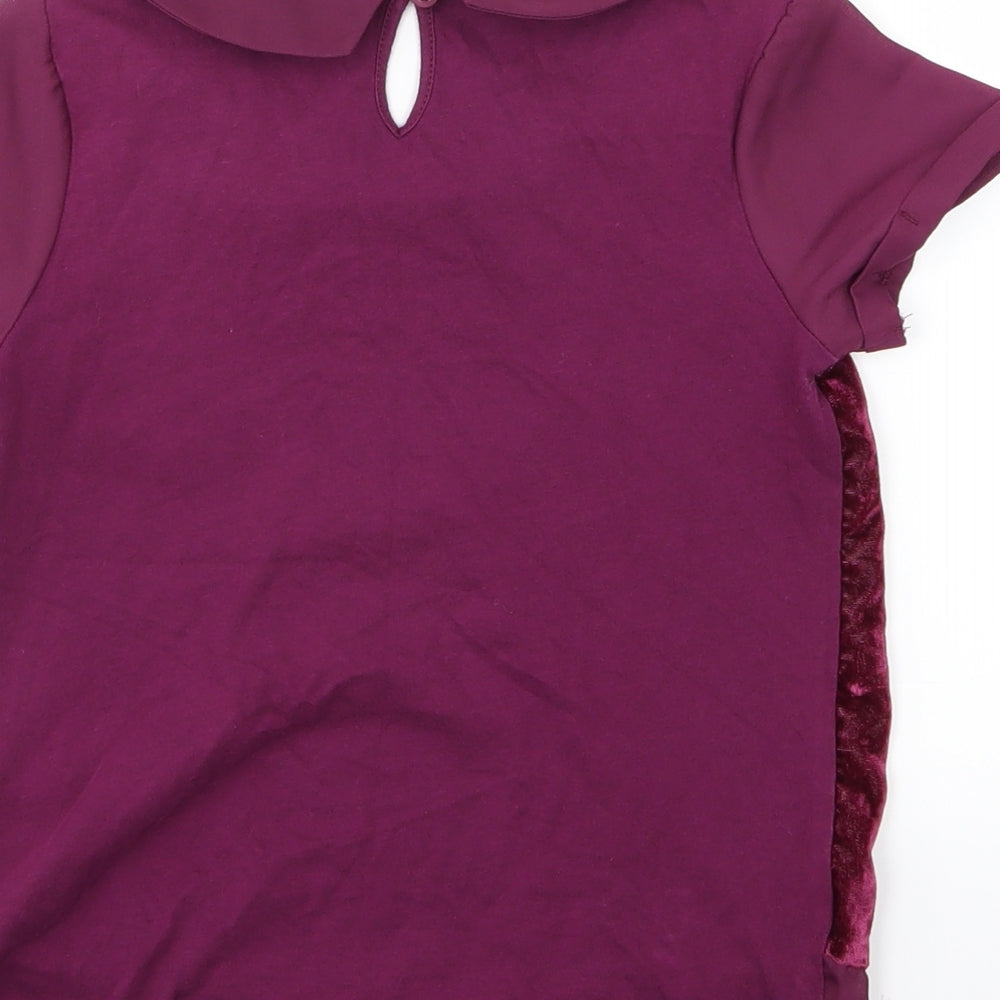 Brand and care label for Next girls’ purple velour basic blouse, size 7, years
