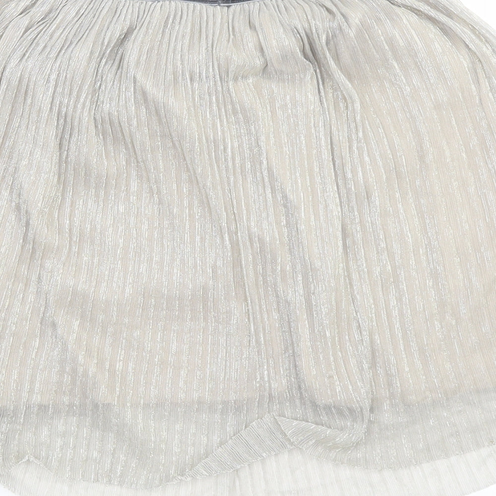 Brand and care label for Next girls’ silver pleated skirt, size 10, years