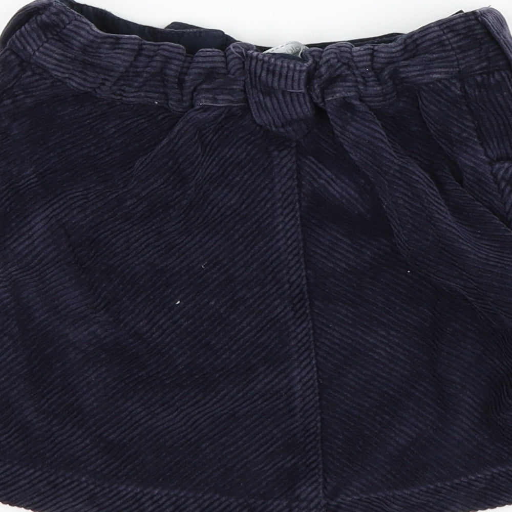 Brand and care label for Pumpkin Patch girls’ blue corduroy a-line skirt, size 7, years