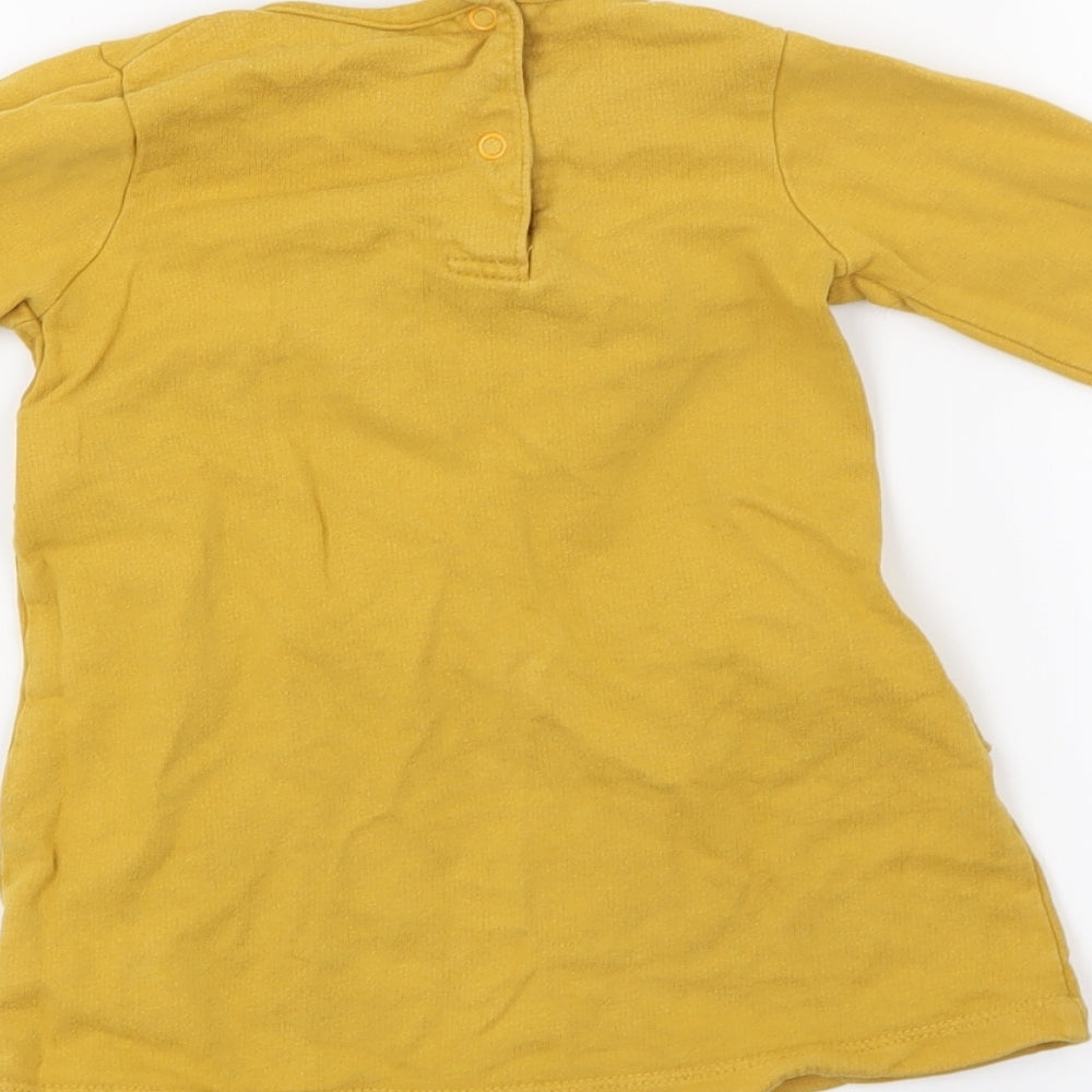 Brand and care label for Tu girls’ yellow shirt dress, size 12-18, months