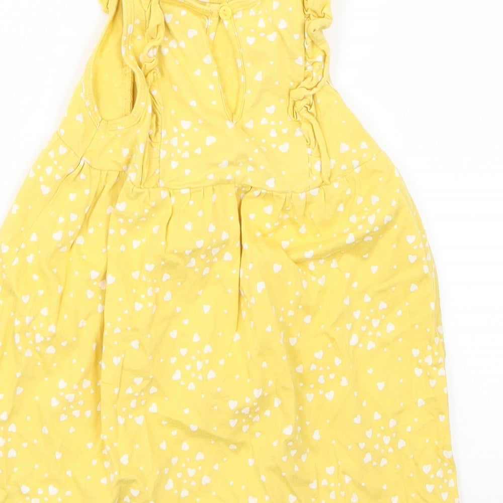 Brand and care label for H&M girls’ yellow geometric shirt dress, size 12-18, months - heart print