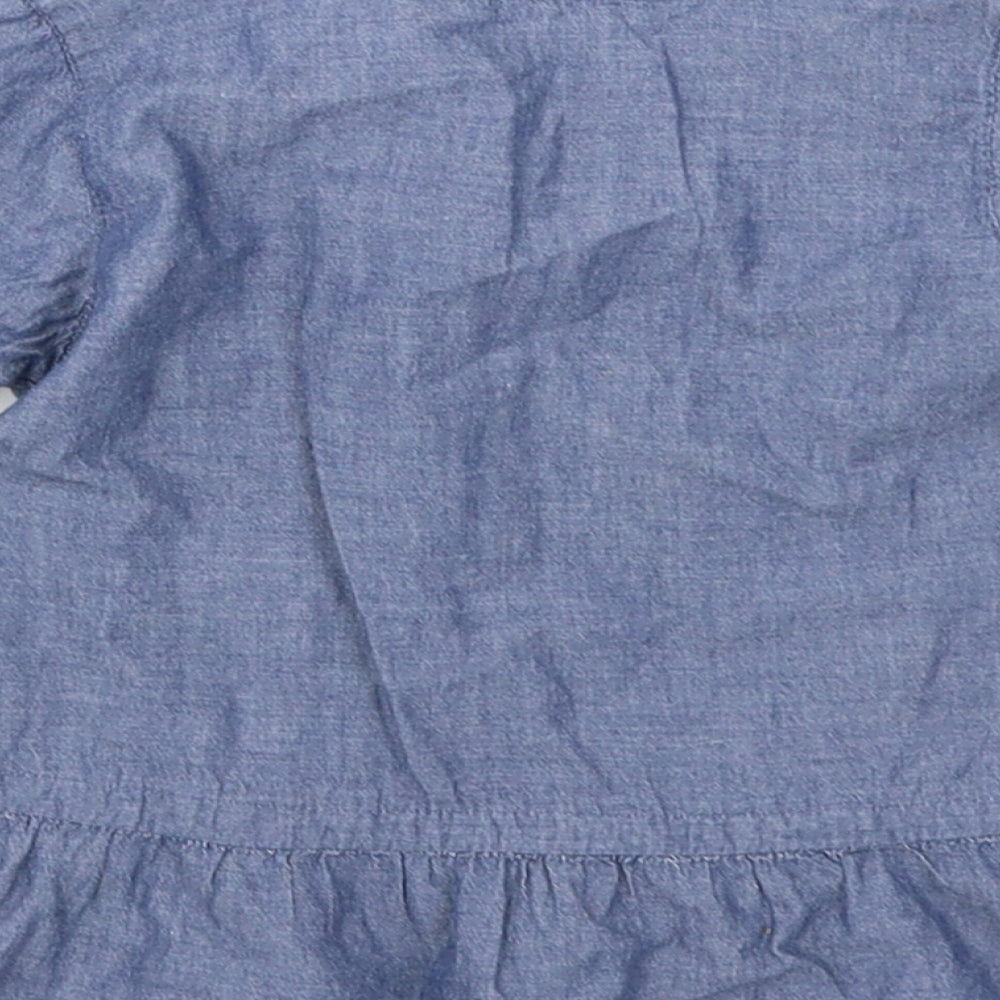 Brand and care label for Matalan girls’ blue denim basic t-shirt, size 6-9, months