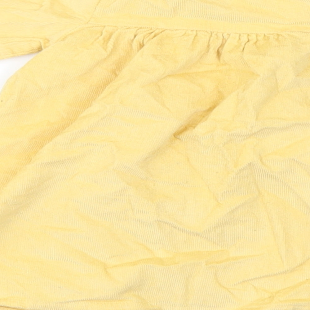 Brand and care label for George girls’ yellow floral corduroy a-line, size 3-6, months