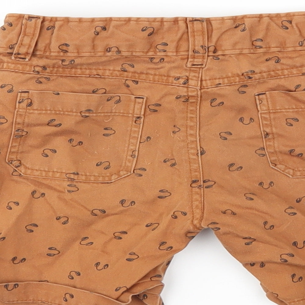 Brand and care label for Cherokee boys’ brown chino shorts, size 3-4, years - headphones