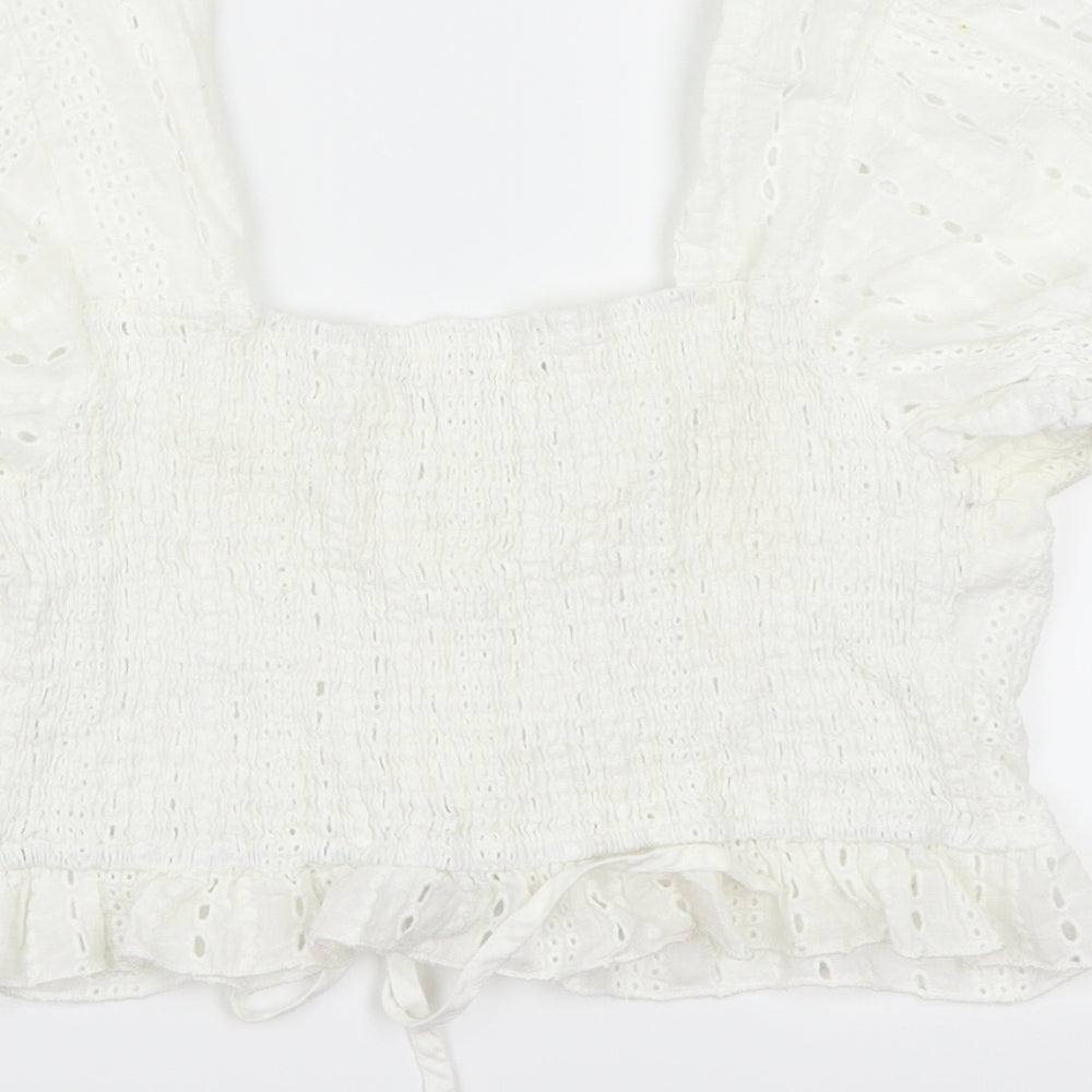 Brand and care label for ROMWE women’s white cropped blouse, size L