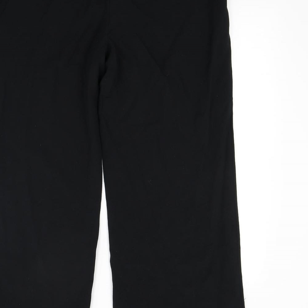 Brand and care label for Marks & Spencer women’s black trousers, size UK 32, in, 28-inch leg
