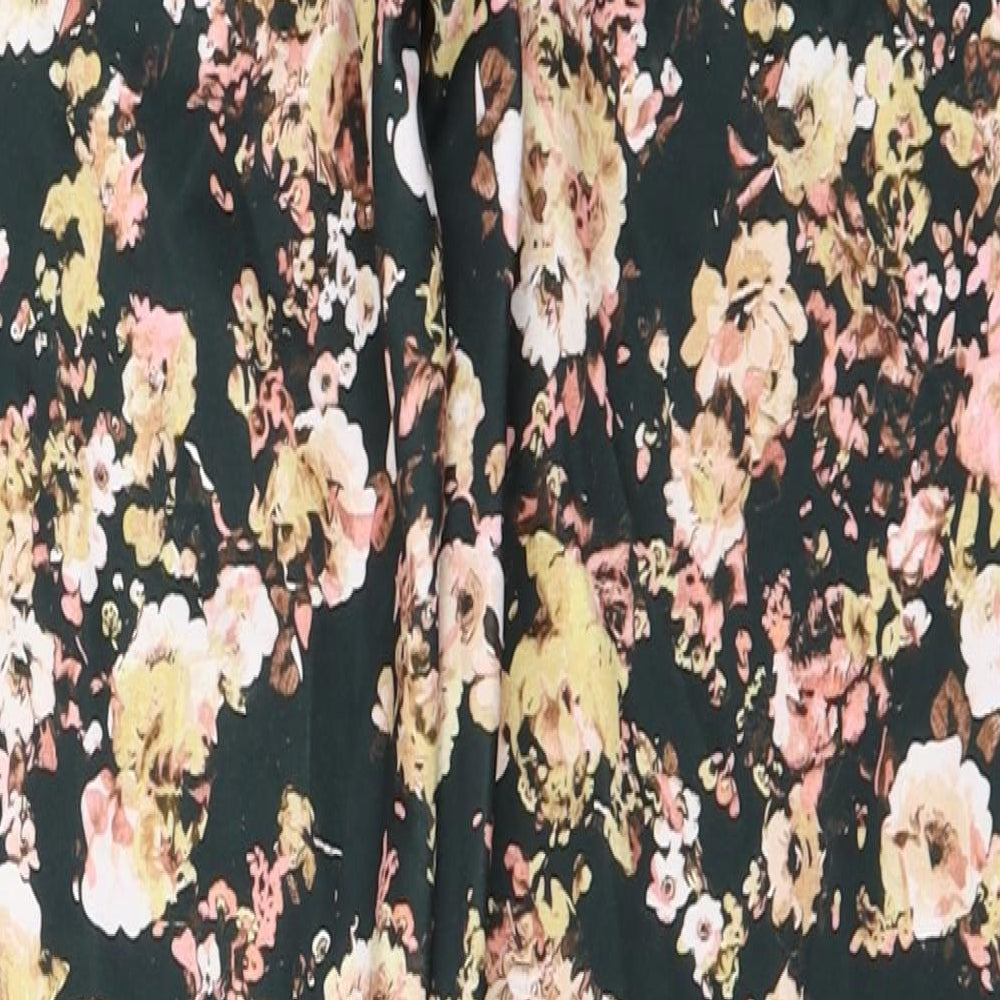 Brand and care label for Boohoo women’s green floral trousers, size UK 12, 24-inch leg