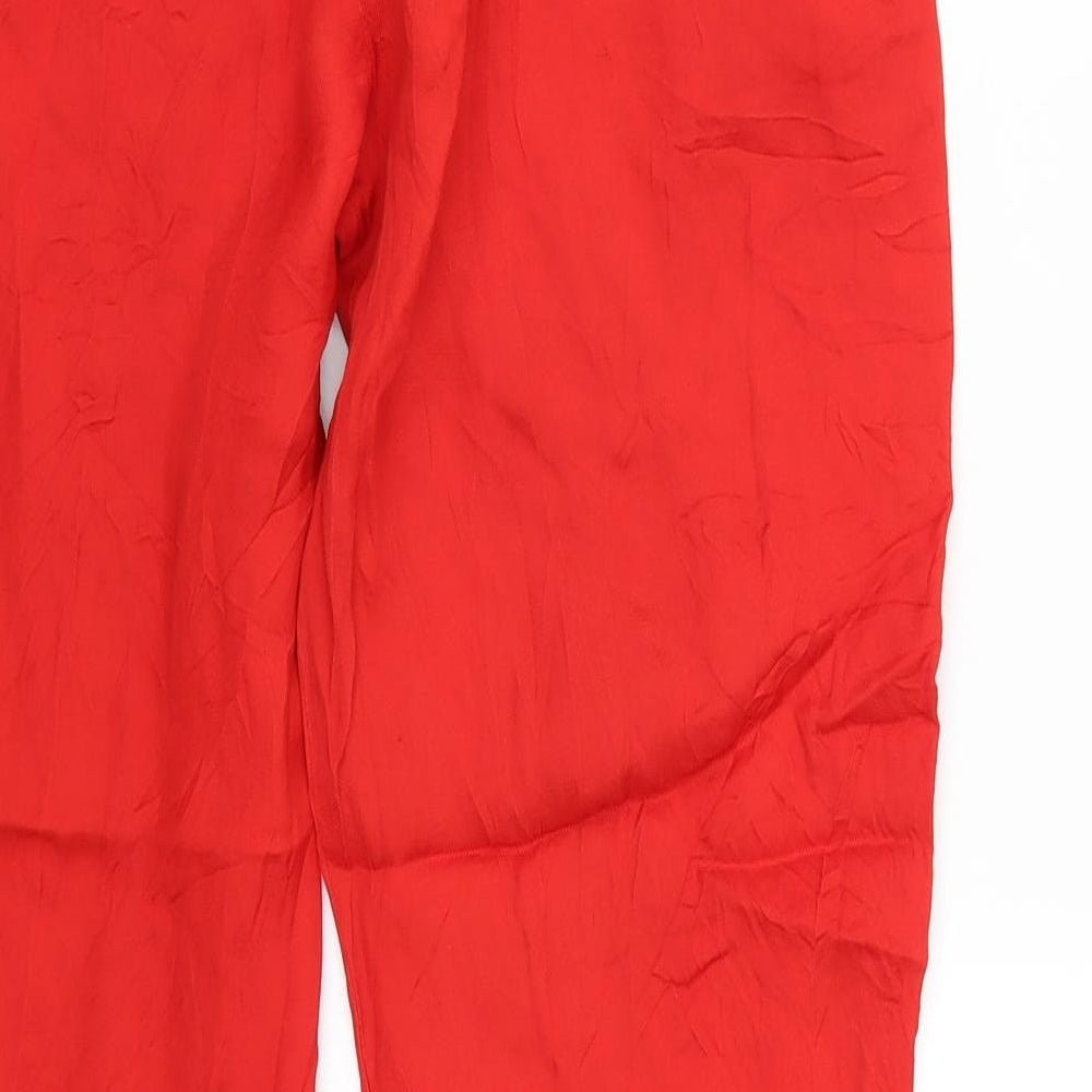 Brand and care label for H&M women’s orange trousers, size UK 10, 28-inch leg