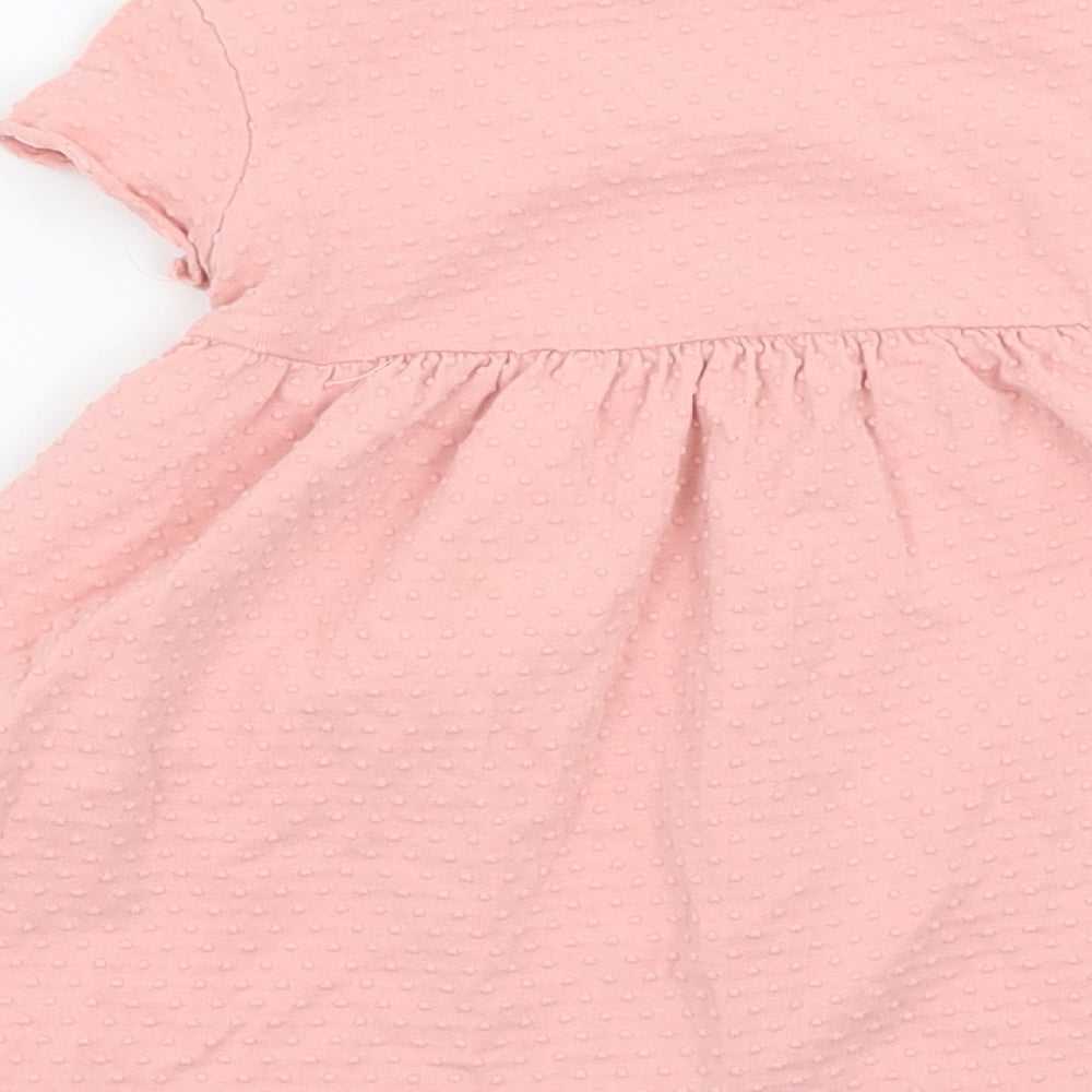 Brand and care label for Maine New England girls’ pink floral jersey t-shirt dress, size 6-9, months