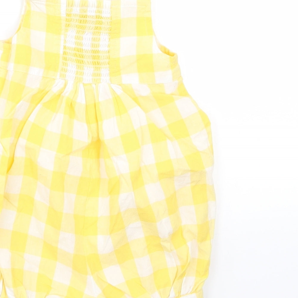 Brand and care label for Monsoon girls’ yellow check pinafore/dungaree dress, size 0-3, months