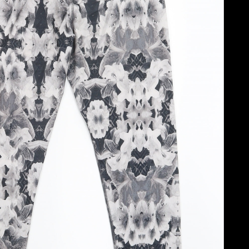 Brand and care label for Energie girls’ black floral cropped trousers, size L