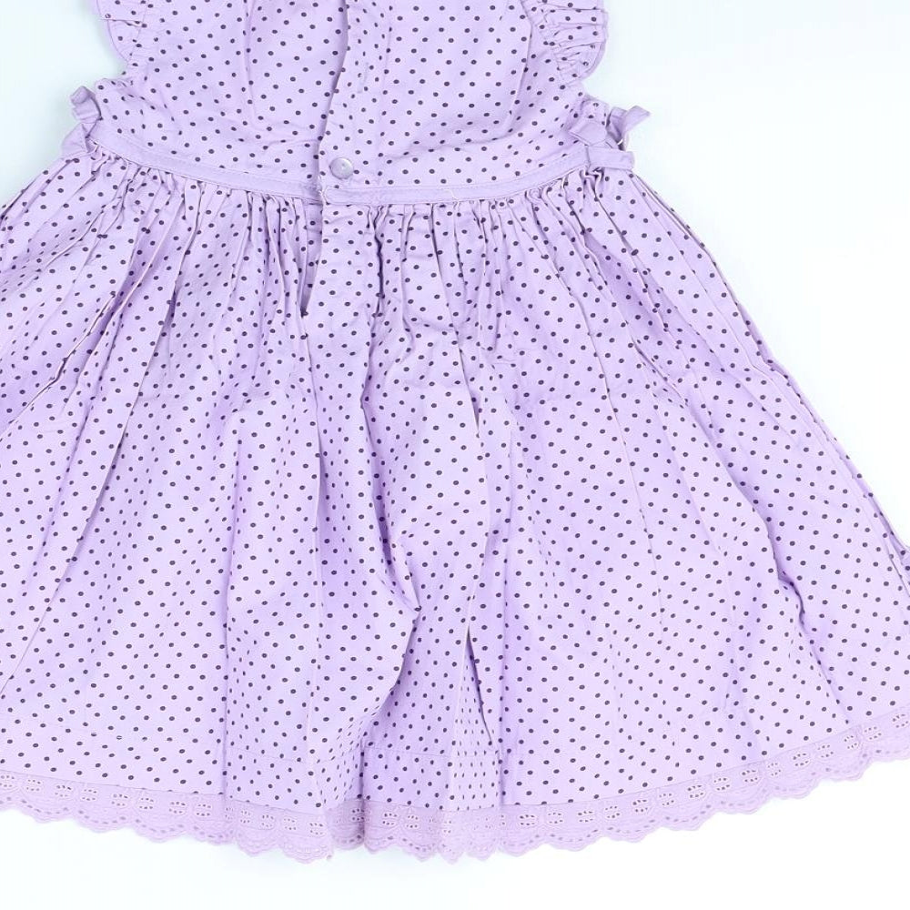 Brand and care label for M&Co girls’ purple polka dot fit & flare, size 12, months
