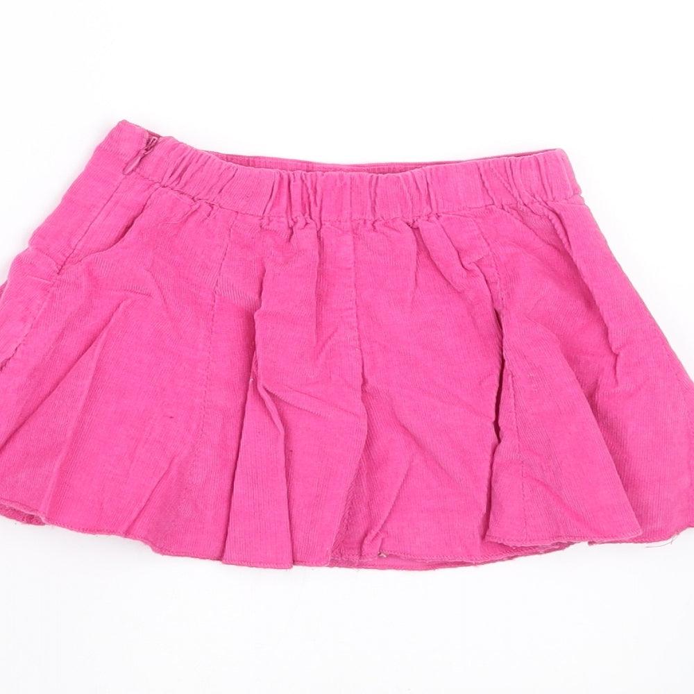 Brand and care label for Early Days girls’ pink a-line skirt, size 6-9, months