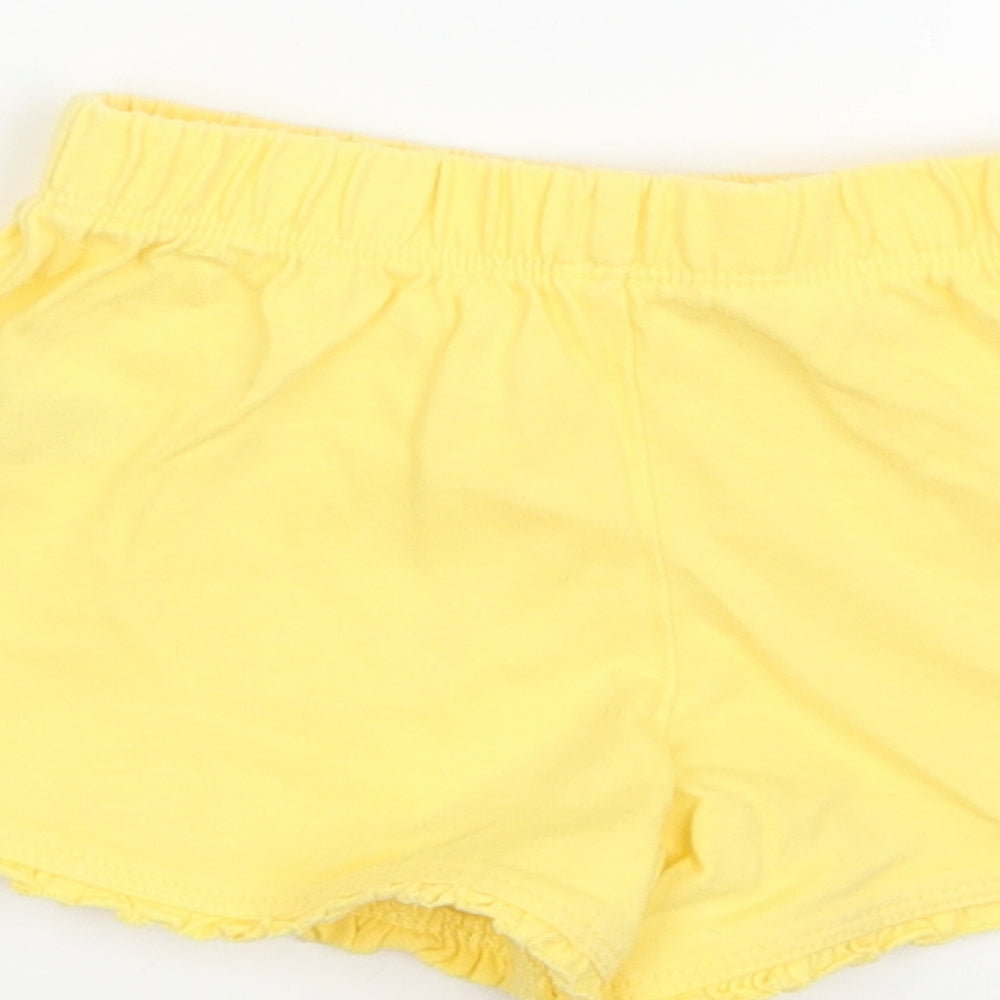 Brand and care label for Mothercare girls’ yellow cropped trousers, size 12-18, months