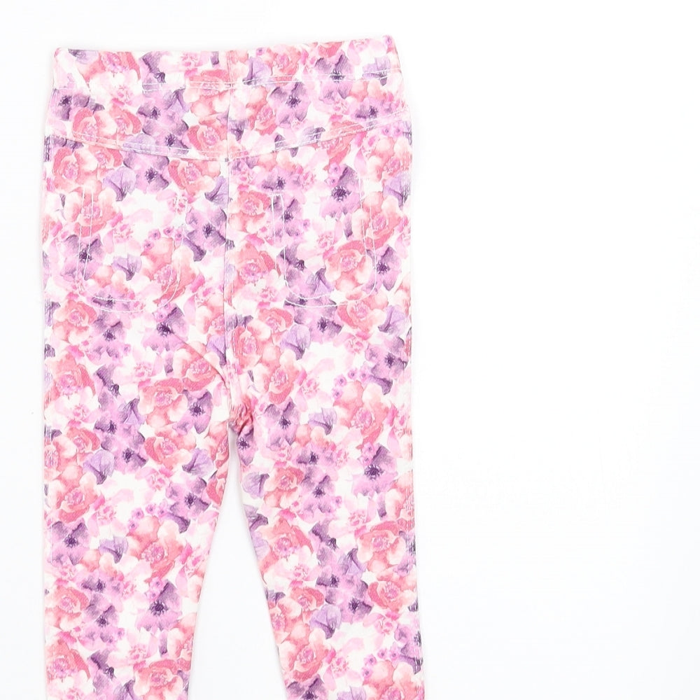 Brand and care label for Matalan girls’ pink floral trousers, size 9-12, months