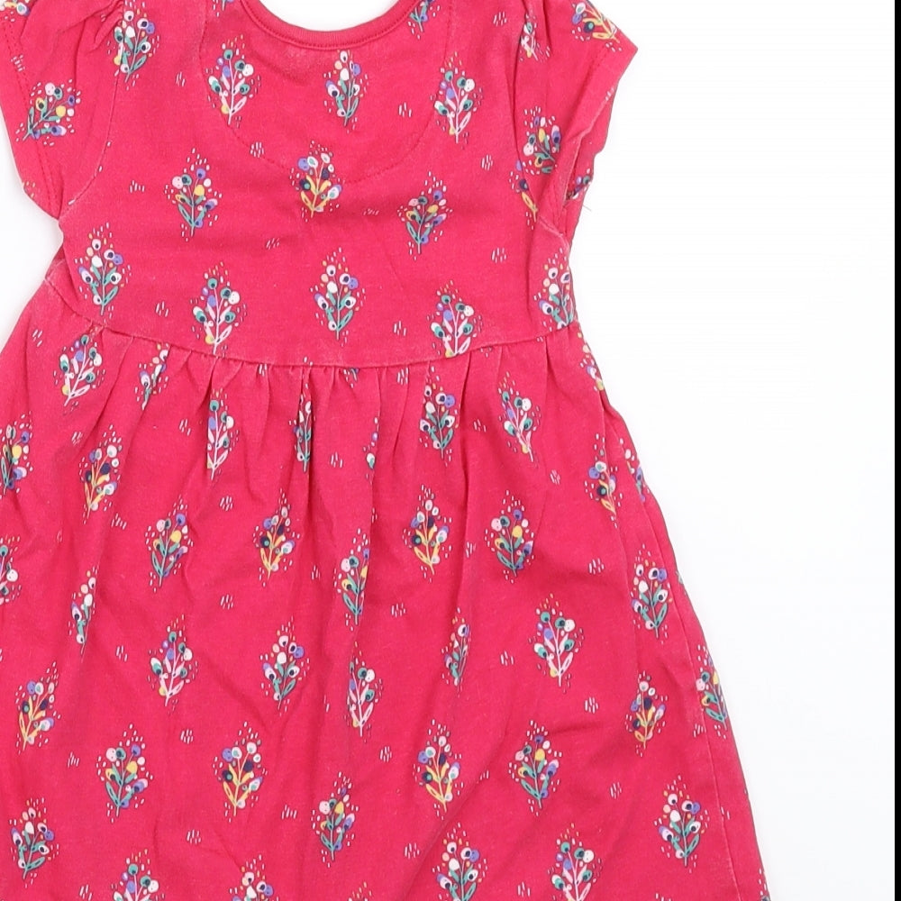 Brand and care label for Mini Club girls’ pink floral t-shirt dress, size 12-18, months
