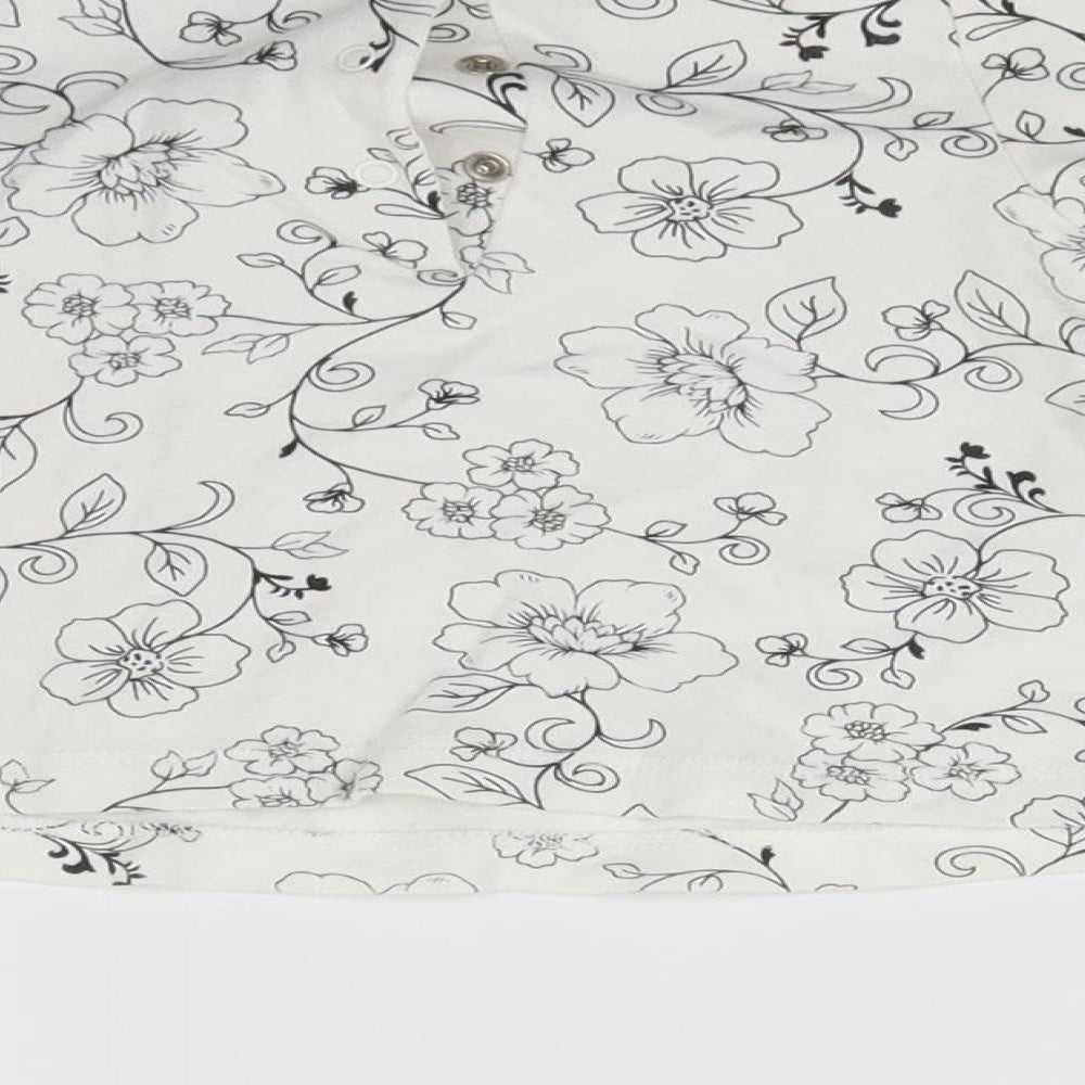 Brand and care label for Little Me girls’ white floral fit & flare, size 6-9, months